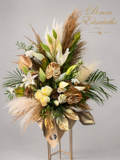 golden delight - A fresh arrangement made with elegant flowers, luxurious pampas, beautiful anthuriums and luxury roses placed into a hat box containing floral foam with a range of unique foliages
