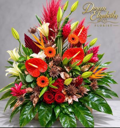 luxury hat box - This floral arrangement is made in a hat box, it certainly gives the wow factor! it contains flowers such as sun flowers, lilies, gerbera, anthurium, dried spear palms and gold foliage.