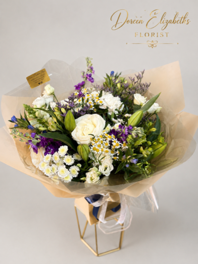 Oceanic Bliss - Revel in the elegance of this luxurious bouquet, featuring a captivating mix of white and blue blooms. Presented in beautiful packaging, it’s perfect for making a sophisticated statement.
