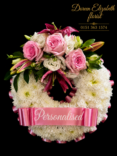 Pink Massed Wreath - At ##SHOP## we are delighted to present this product available for flower delivery in ##AREA## and surrounding areas.