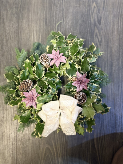 pink fresh wreath - fresh wreath made on moss frame with spruce, holly, pine cones and artificial pink glitter poinsettia. finished with a beautiful bow
