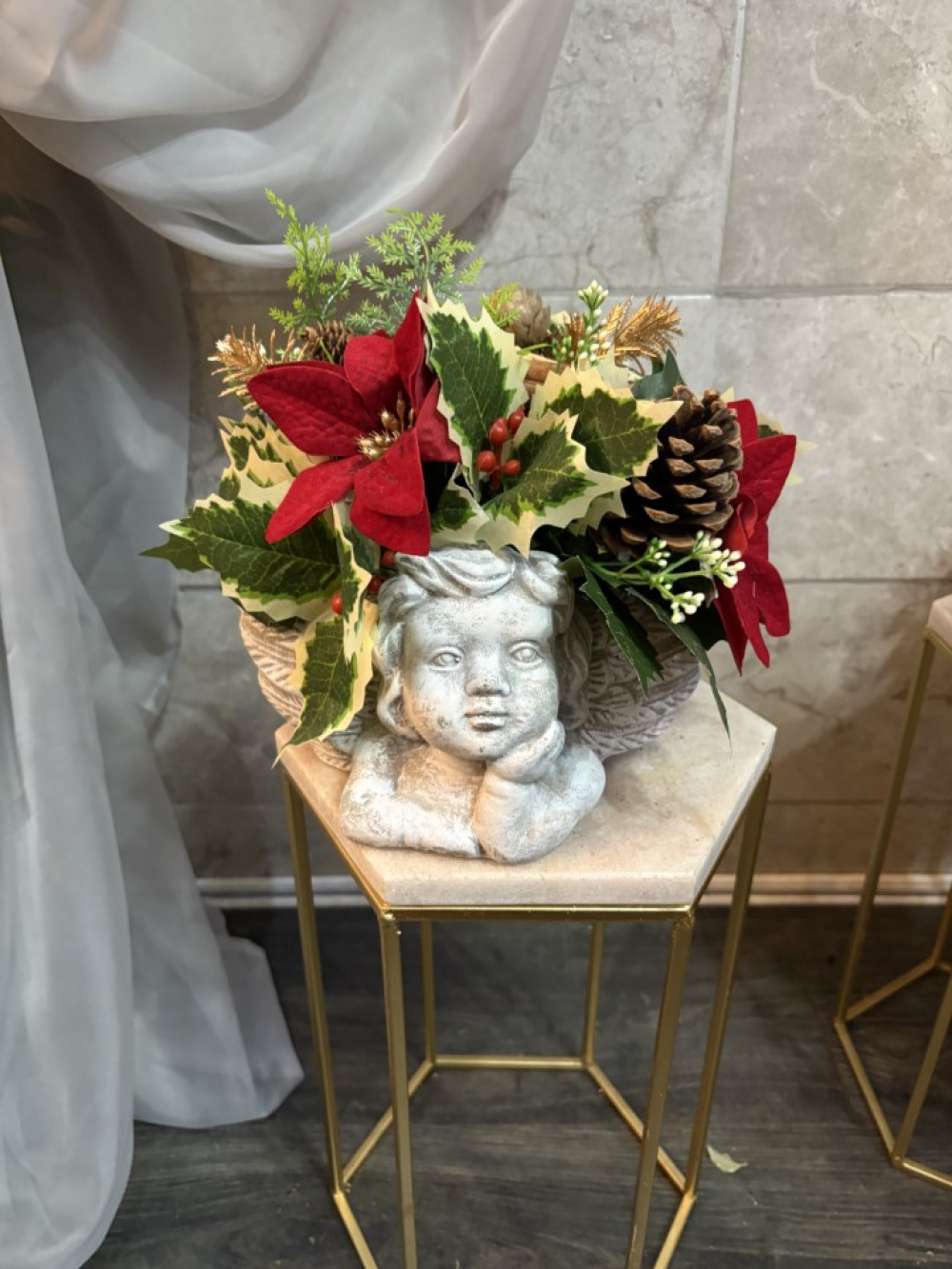 cherub planter with red flowers