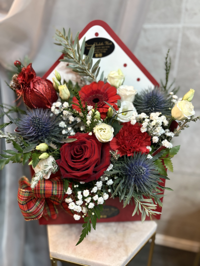 sending christmas love - a selection of fresh seasonal flowers and foliage with a christmas bauble